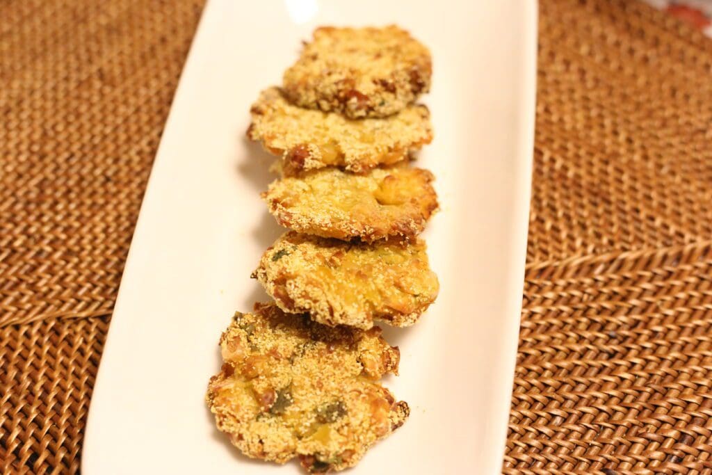 Fried fritters on a white rectangular plate.